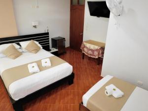 En eller flere senge i et værelse på Hotel Tambopata Inn