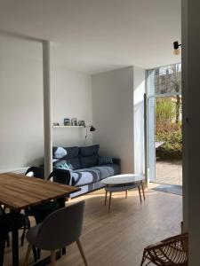 a living room with a couch and a table at La Parisette in La Bourboule +12 photos