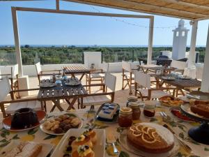 a table with plates of food on top of a roof at Boutique Hotel Masseria Sottomasi in Savelletri di Fasano