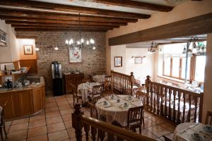 a restaurant with tables and chairs in a room at Logis Hotel Saint-Martin in Colmar