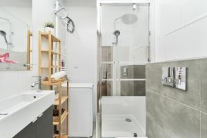 a bathroom with a shower and a sink at Riverside Apartments Na Grobli by Renters in Wrocław