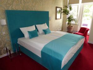 a large bed with a blue headboard in a bedroom at Berlinapartments-Downtown in Berlin