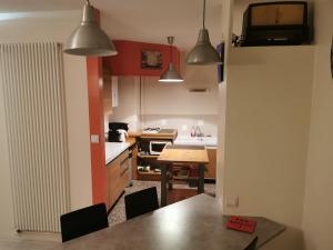 a kitchen with a table and chairs in it at Bagneres de luchon Hyper Centre in Luchon