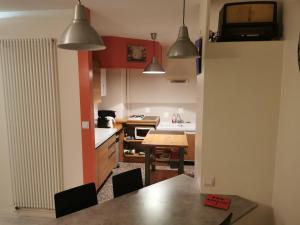 a kitchen with a table and chairs in it at Bagneres de luchon Hyper Centre in Luchon +2 photos