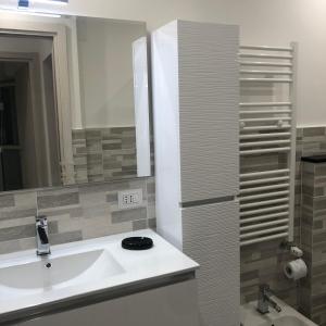 a bathroom with a sink and a mirror at La Casa di Gio in Rapallo