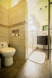 a bathroom with a toilet and a sink at Palo Rosa in Quepos