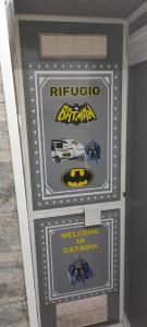 a sign for a super show with batman and a car at Batman Airport Catania City in Catania
