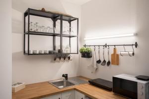 a kitchen with a sink and a counter with utensils at APARTMENT SAPICA in Solkan