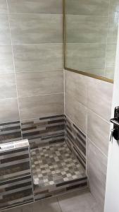 a shower stall with a tiled floor in a room at Luxury Suites at The Square Duplex Townhouse in Springfield