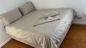 a bed with a bag on top of it at Luxury Suites at The Square Duplex Townhouse in Springfield
