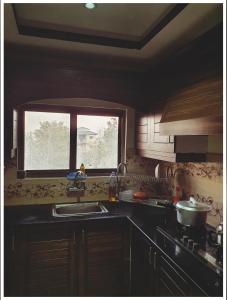 a kitchen with a sink and a window at Full Serviced Cottage in Bhurban in Ausia