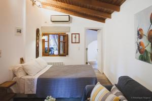 1 dormitorio con 1 cama y 1 sofá en Small Guesthouse In The Garden, en Amarinto