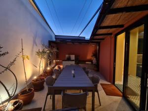 a dining room with a table and some plants at Selin the stone house in Phini