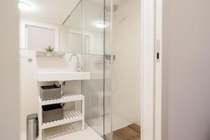 a bathroom with a sink and a shower at Nockventure Apartment Nockberge in Ebene Reichenau