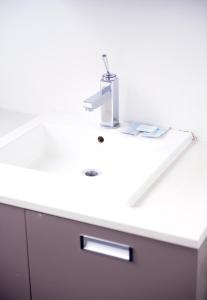 a white bathroom sink with a faucet on it at Aparthotel Van Hecke in Antwerp