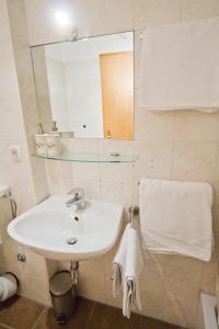a bathroom with a sink and a mirror and towels at Jerry & Oli's Apartments in Šibenik +63 photos