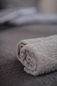 a white towel sitting on top of a bed at Aparthotel Van Hecke in Antwerp