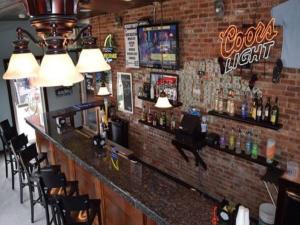 a bar in a restaurant with a brick wall at Hershey Motel in Seaside Heights