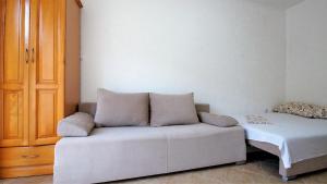 a living room with a couch and a bed at MM Apartments in Budva