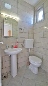 a bathroom with a toilet and a sink at MM Apartments in Budva