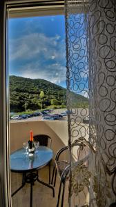 a table with a bottle of wine on a balcony at MM Apartments in Budva