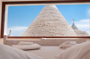 a bedroom with a bed with two towels on it at Trulli Loco in Locorotondo