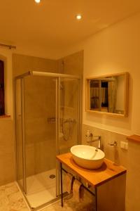 a bathroom with a sink and a shower at Ferienwohnung Stöckl in Grabenstätt