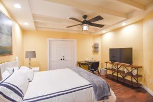 a bedroom with a bed and a flat screen tv at Quinta Pacifica Beachfront Villas in Rosarito