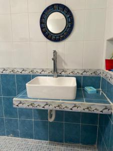 a bathroom with a sink and a mirror at Villa Gaviotas el cuyo beach in El Cuyo +10 photos