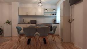 a kitchen with a dining room table and chairs at Chrysanthemum in Sighişoara