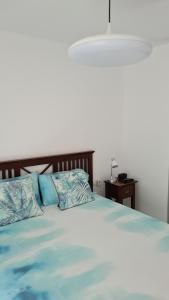 巴哈馬爾的住宿－Apartamento en Bajamar -Tenerife，一间卧室配有一张带蓝色枕头的床