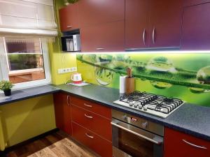 a kitchen with purple cabinets and a stove top oven at M&M Apartment II SELF CHECK-IN in Panevėžys