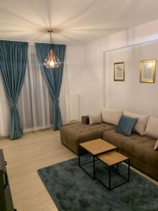 a living room with a couch and a table at Luxury Studio in Bucharest