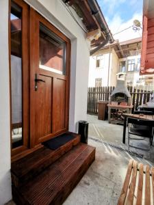 a wooden door on a house with a bench at Casa Bunicilor Sinaia in Sinaia