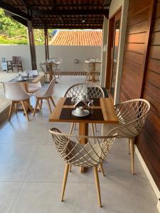 a patio with tables and chairs on a patio at Pousada Alma Noronha in Fernando de Noronha