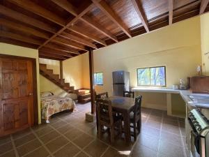 a room with a kitchen and a table and a bed at Two houses with a private pool. in Pavones