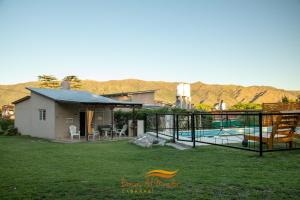 een achtertuin met een zwembad en een huis bij Cabañas Brisas Del Mirador in Bialet Massé