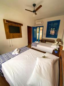 A bed or beds in a room at Pousada Doce Villa