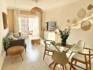 a living room with a glass table and chairs at Casa del Sol - with Home Office space in Playa de San Juan