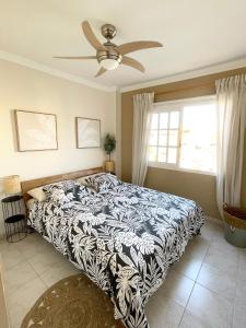a bedroom with a bed and a ceiling fan at Casa del Sol - with Home Office space in Playa de San Juan +15 photos