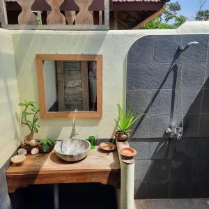 a bathroom with a sink and a mirror at Harry's Ocean House Pacitan in Pacitan