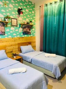 Postel nebo postele na pokoji v ubytování Ghazzis Suite Cameron Highland
