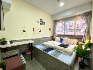 Posteľ alebo postele v izbe v ubytovaní Hong Kong Hostel (Tsim Sha Tsui Mansion)