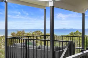 a balcony with a view of the ocean at YARABIN - Luxury Home With Ocean Views in Point Lookout