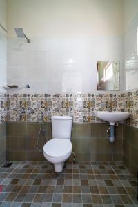 a bathroom with a toilet and a sink at Almas Residency in Cochin