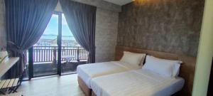 Schlafzimmer mit einem Bett und einem Fenster mit einem Balkon in der Unterkunft Cube Bed Station & Tours Sdn Bhd in Semporna