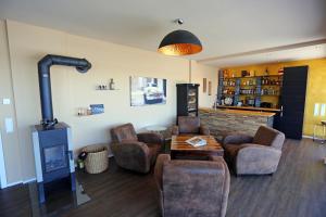 a living room with a wood stove and chairs at Rhein Lounge in Urmitz