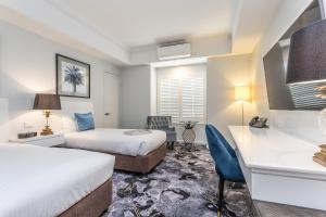 Giường trong phòng chung tại Kingsford Smith Motel