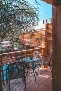 a patio with two chairs and a table on a deck at The Bridge Dahab in Dahab