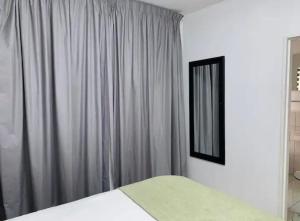 a bedroom with a bed and a mirror and curtains at Lillys Quarter 1 - Newly Renovated! in Sandton